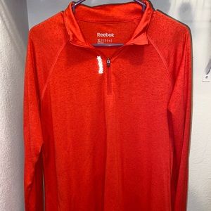Red/orange quarter zip athletic shirt